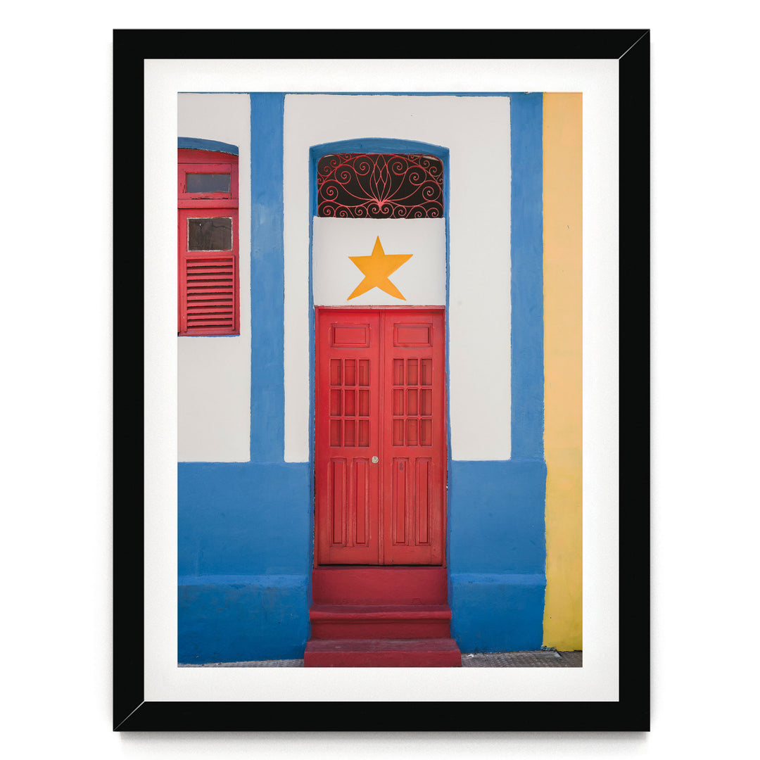 Red Door with Yellow Star, Olinda, Brazil print in a black frame with white mat