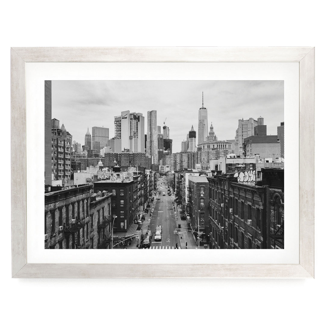 Lower Manhattan Street View, New York City – B&amp;W print in a silver frame with white mat
