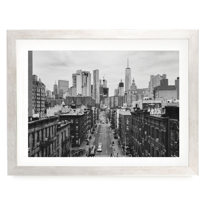 Lower Manhattan Street View, New York City – B&amp;W print in a silver frame with white mat