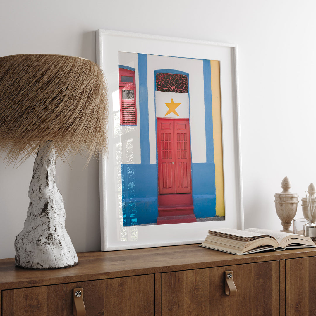 Red Door with Yellow Star, Olinda, Brazil print displayed in a bedroom setting