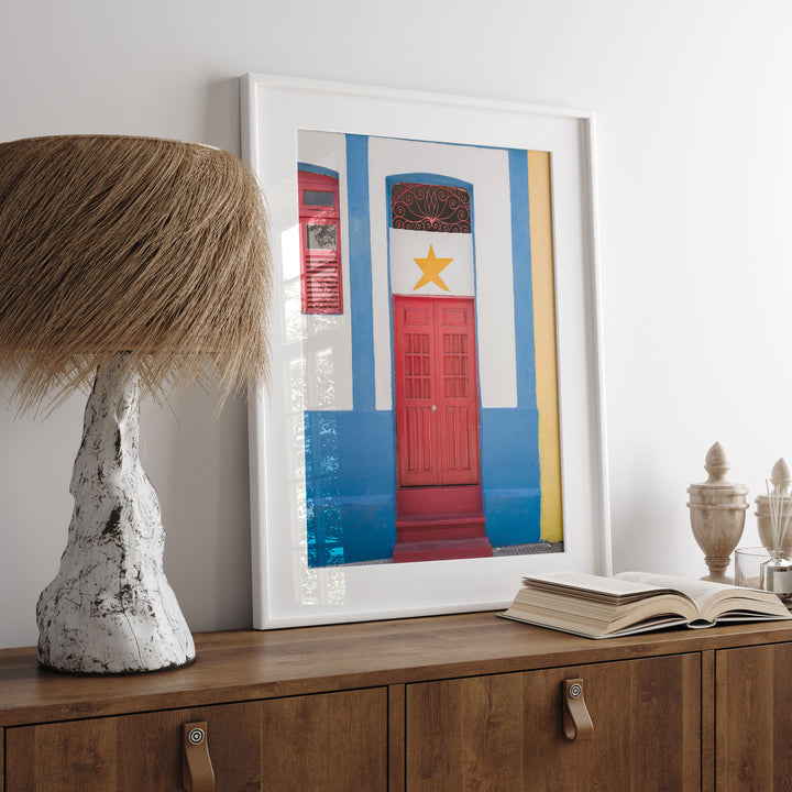 Red Door with Yellow Star, Olinda, Brazil print displayed in a bedroom setting