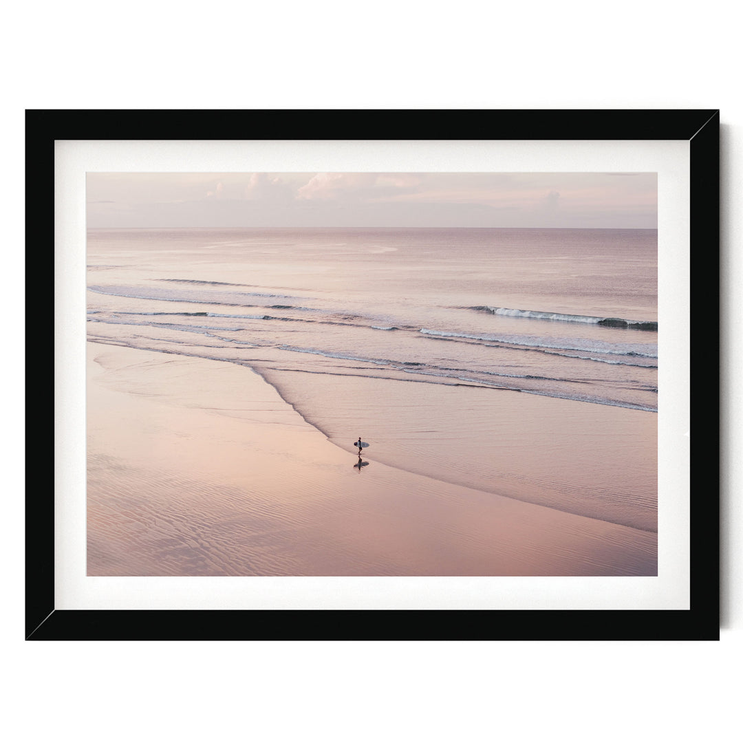 Lone Surfer on a Pink Beach I, Costa Rica print in a black frame with white mat