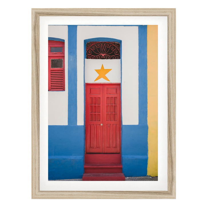 Red Door with Yellow Star, Olinda, Brazil fine art print in a natural wood frame with white mat