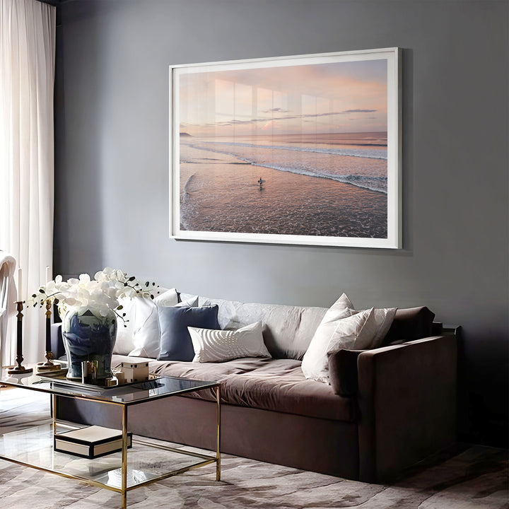 Lone Surfer on a Pink Beach II, Costa Rica print displayed in a bedroom setting