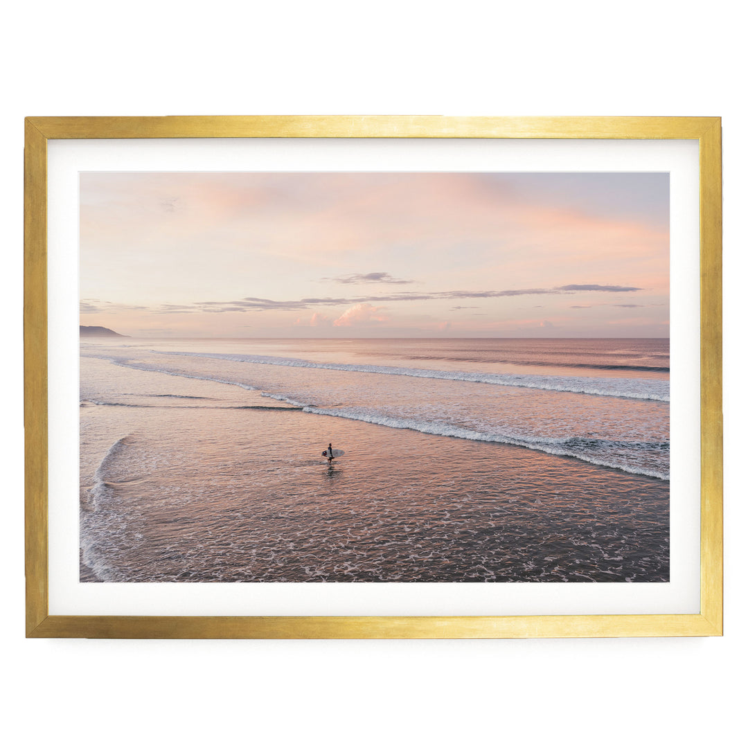 Lone Surfer on a Pink Beach II, Costa Rica print in a gold frame with white mat