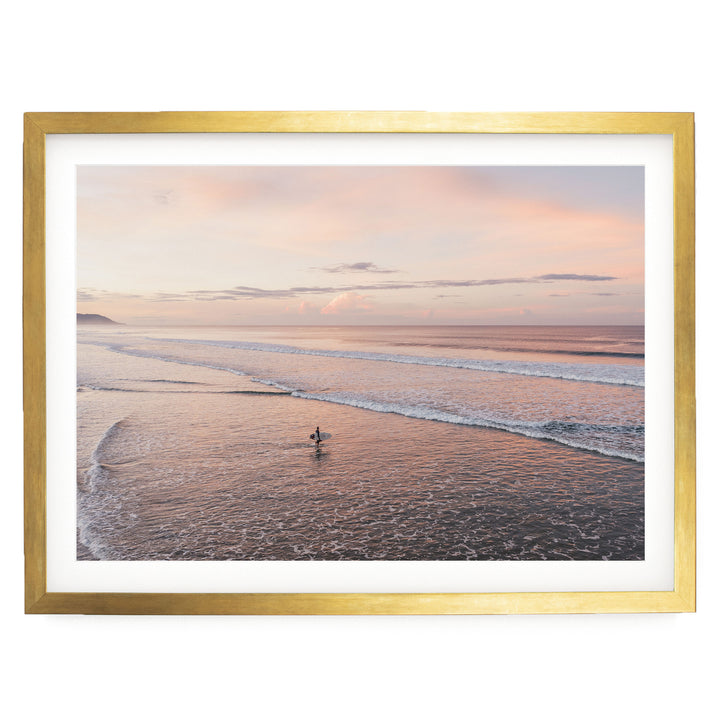 Lone Surfer on a Pink Beach II, Costa Rica print in a gold frame with white mat