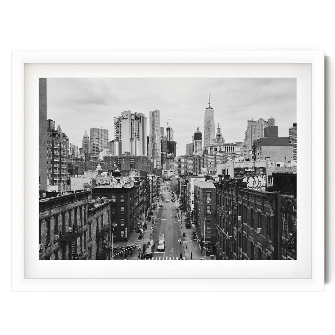 Lower Manhattan Street View, New York City – B&amp;W print in a white frame with white mat