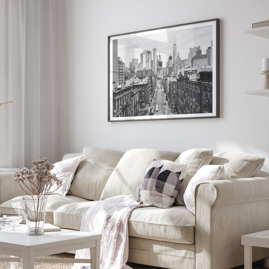Lower Manhattan Street View, New York City – B&amp;W framed print in a living room setting