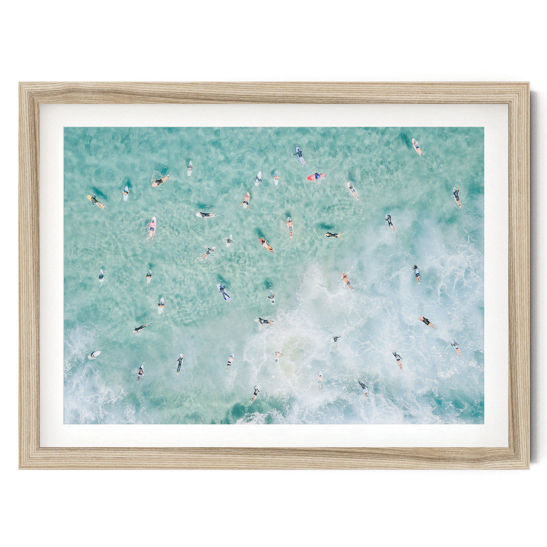 Bondi Beach surfers aerial print in a natural wood frame with white mat