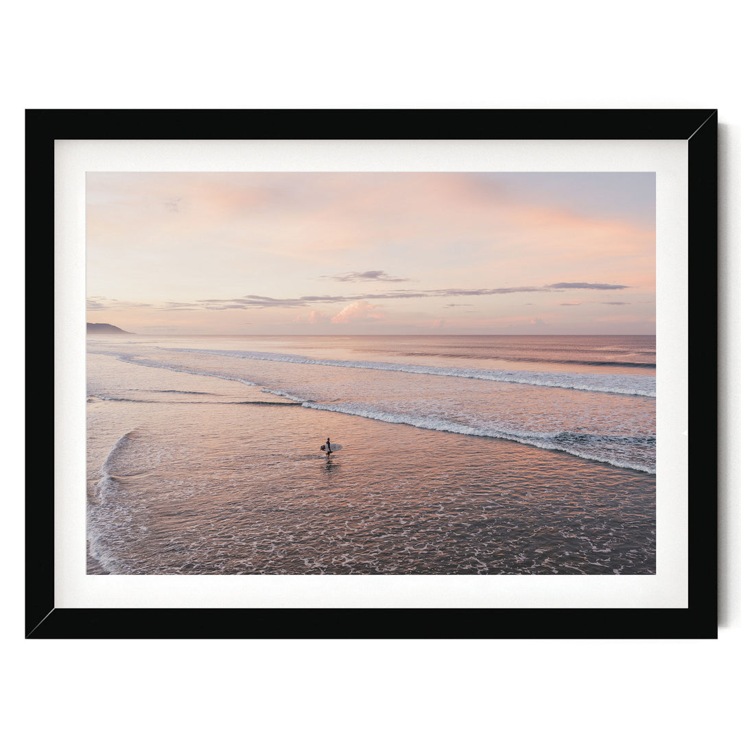 Lone Surfer on a Pink Beach II, Costa Rica print in a black frame with white mat