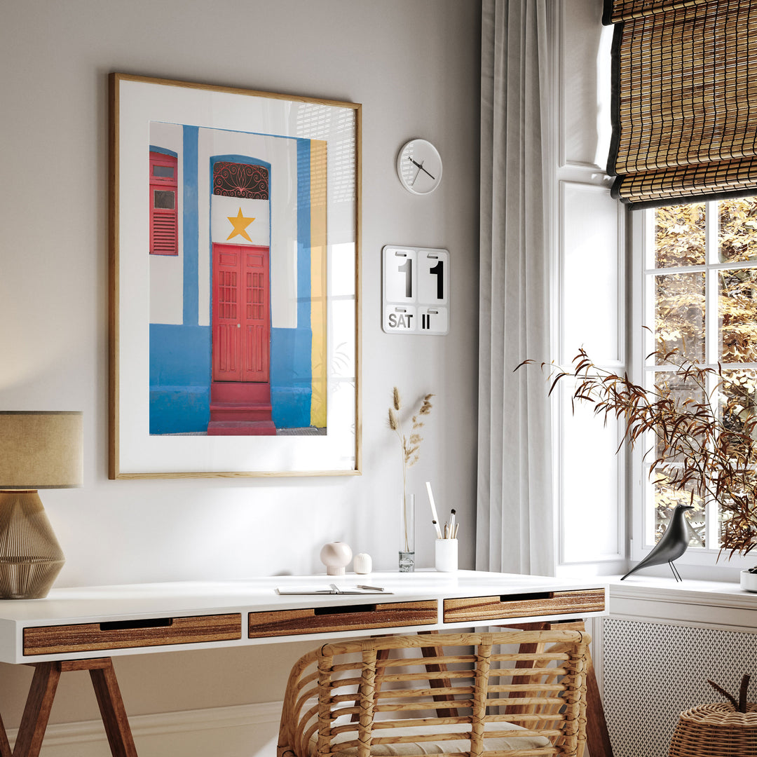 Red Door with Yellow Star, Olinda, Brazil framed print hanging in a styled interior