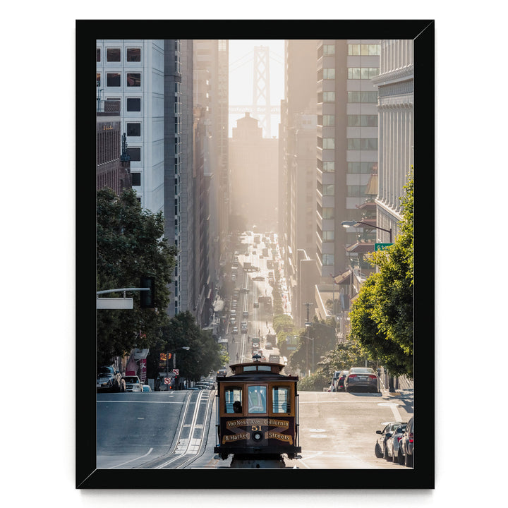 A trolley car travels down a busy street in San Francisco, surrounded by tall buildings and lush green trees.