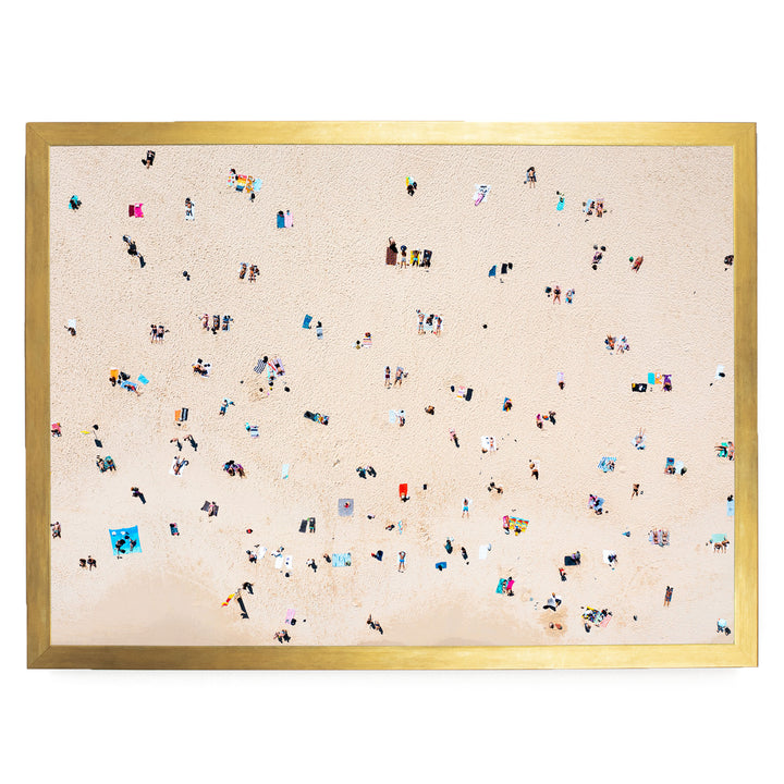 The image is a collage of multiple images depicting people on a beach, with a large number of individuals scattered across the sandy surface.
