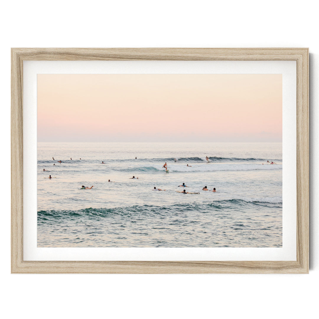 a group of people enjoying themselves in the ocean, with some of them riding waves on surfboards.
