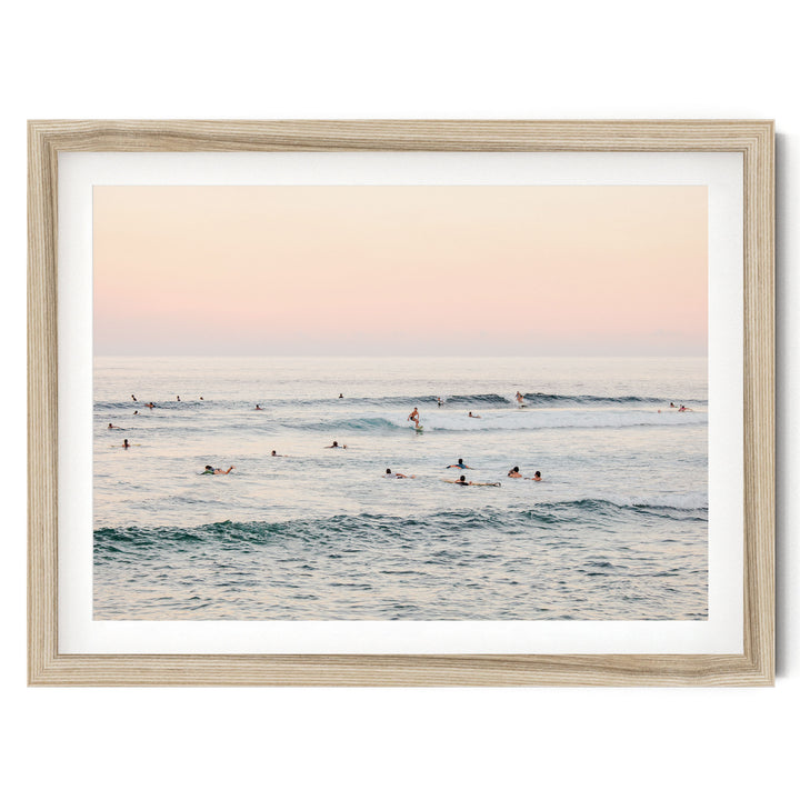 a group of people enjoying themselves in the ocean, with some of them riding waves on surfboards.