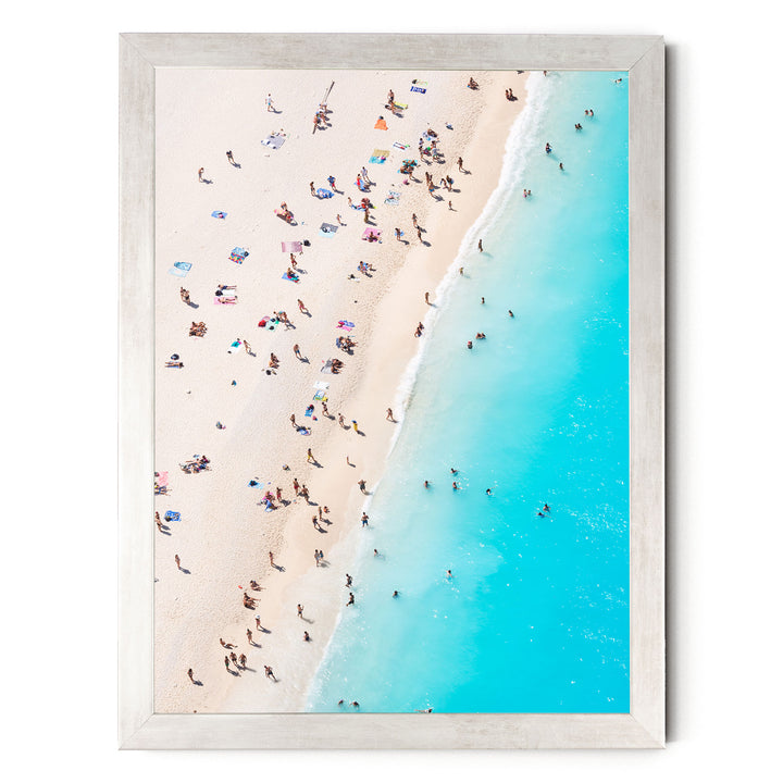 a crowded beach with people enjoying the sun and water.