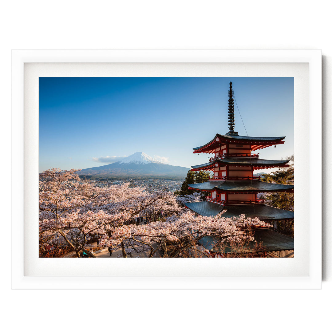 A traditional Japanese pagoda stands in the foreground, with cherry blossom trees in full bloom in the background, against a backdrop of a snow-capped mountain.