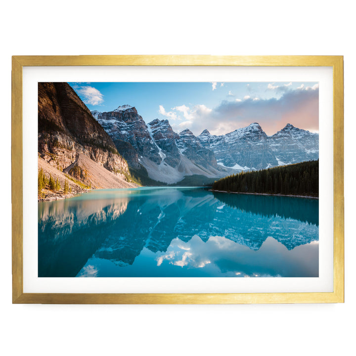A breathtaking landscape featuring a serene lake surrounded by majestic snow-capped mountains, with the mountains' peaks reflected perfectly in the calm waters.