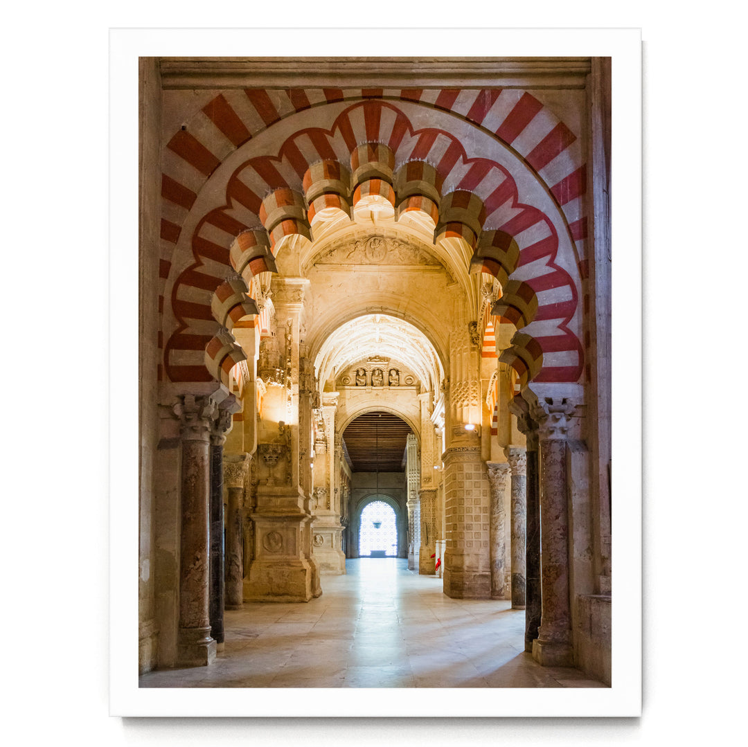 a grand, ornate hallway with arched doorways and intricate architectural details, including red and white striped patterns on the walls.