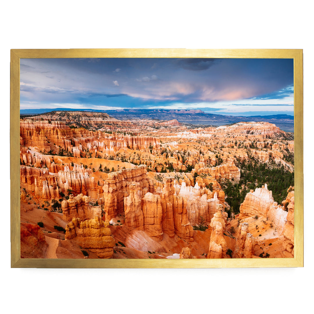 a breathtaking view of a canyon with towering red rock formations, set against a dramatic cloudy sky.