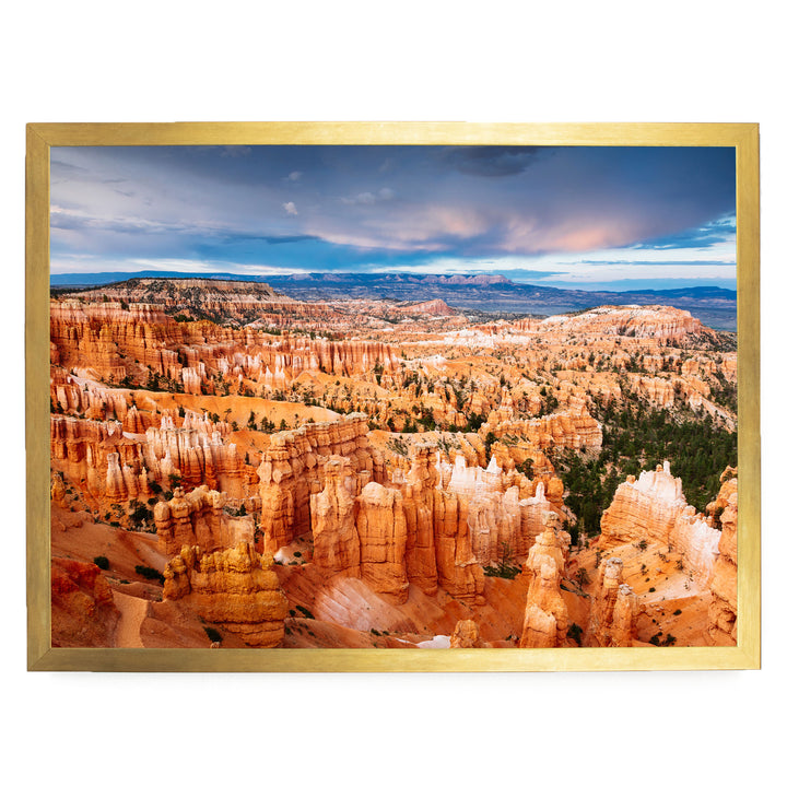 a breathtaking view of a canyon with towering red rock formations, set against a dramatic cloudy sky.