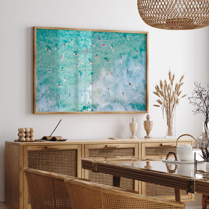 a painting hanging on a wall above a dining room table