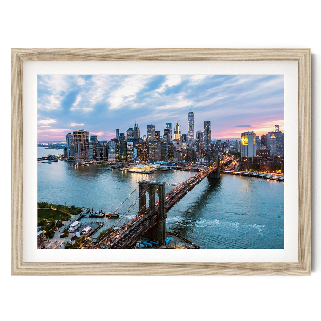 a cityscape with a bridge spanning a river, surrounded by tall buildings and illuminated by the warm glow of the setting sun.