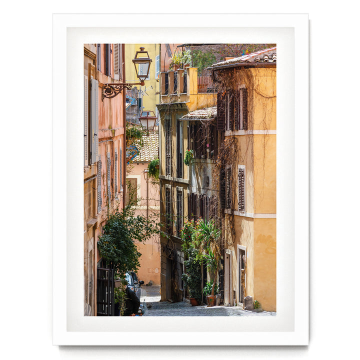 a narrow, charming street lined with colorful buildings, lush greenery, and a variety of potted plants.