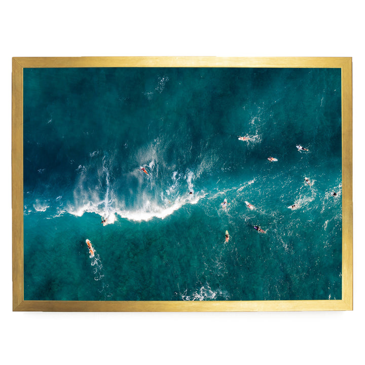 a group of people surfing in the ocean, with waves crashing around them.