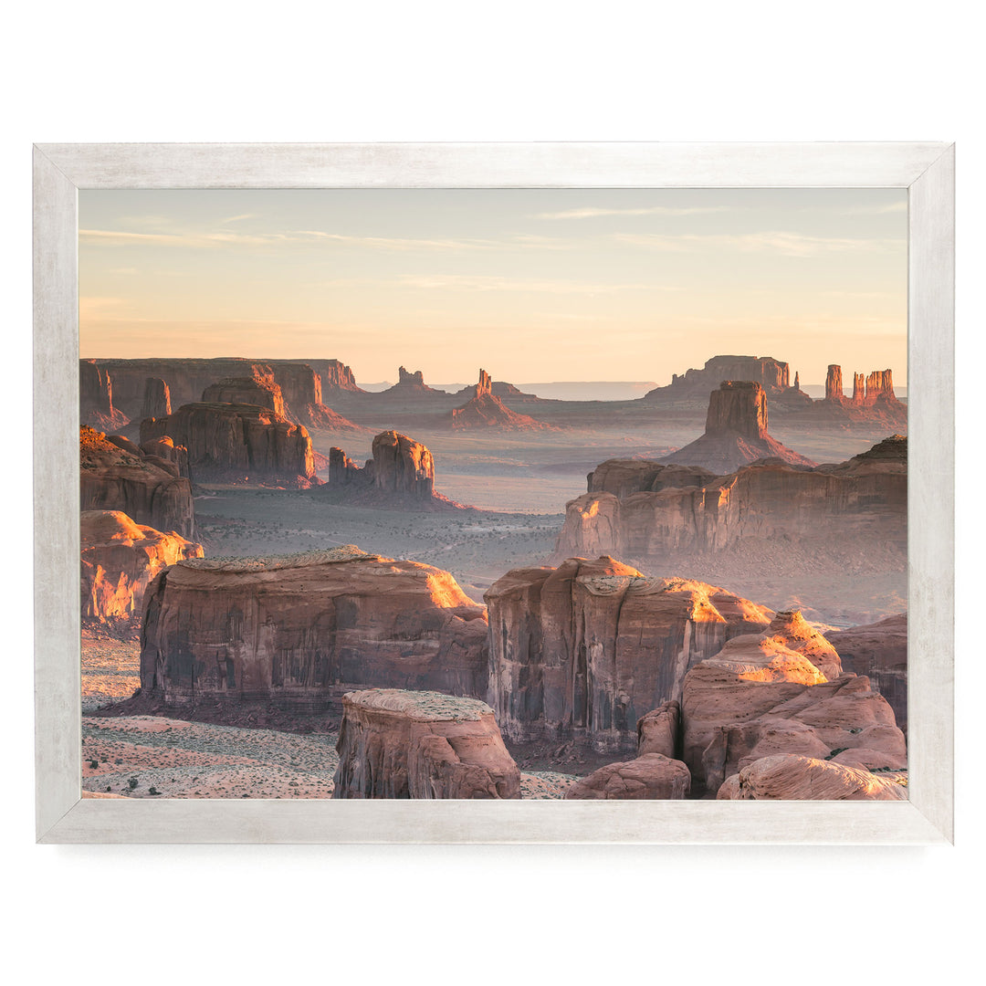 a breathtaking view of the Grand Canyon, with its towering red rock formations bathed in the warm glow of the setting sun. The sky above is a beautiful canvas of orange and pink hues, creating a stunning backdrop for the natural landscape. The image is a collage of multiple images, showcasing the vastness and beauty of the Grand Canyon at sunset.