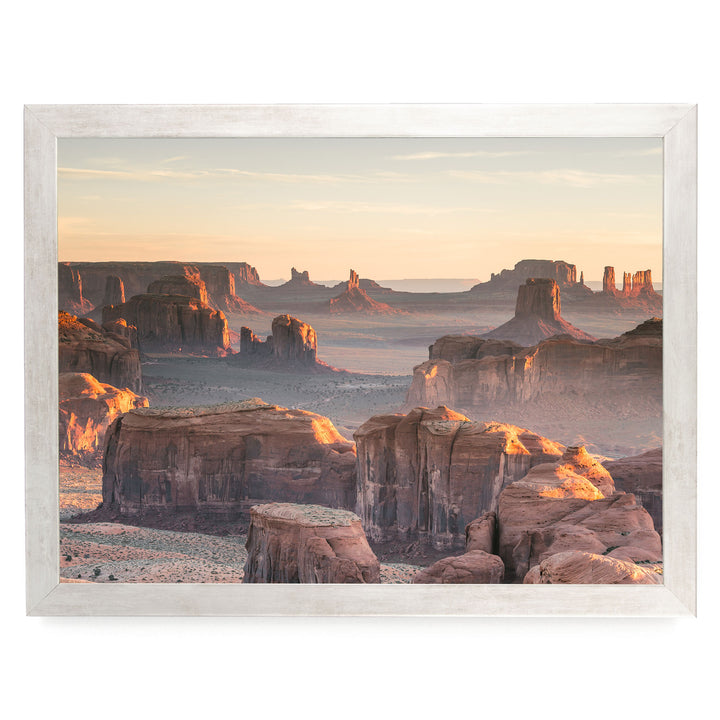a breathtaking view of the Grand Canyon, with its towering red rock formations bathed in the warm glow of the setting sun. The sky above is a beautiful canvas of orange and pink hues, creating a stunning backdrop for the natural landscape. The image is a collage of multiple images, showcasing the vastness and beauty of the Grand Canyon at sunset.