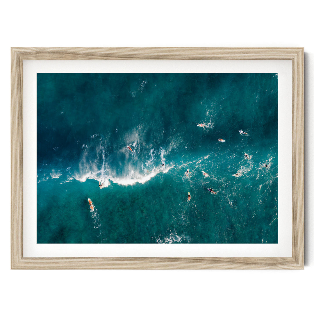 a group of people surfing in the ocean, with waves crashing around them.