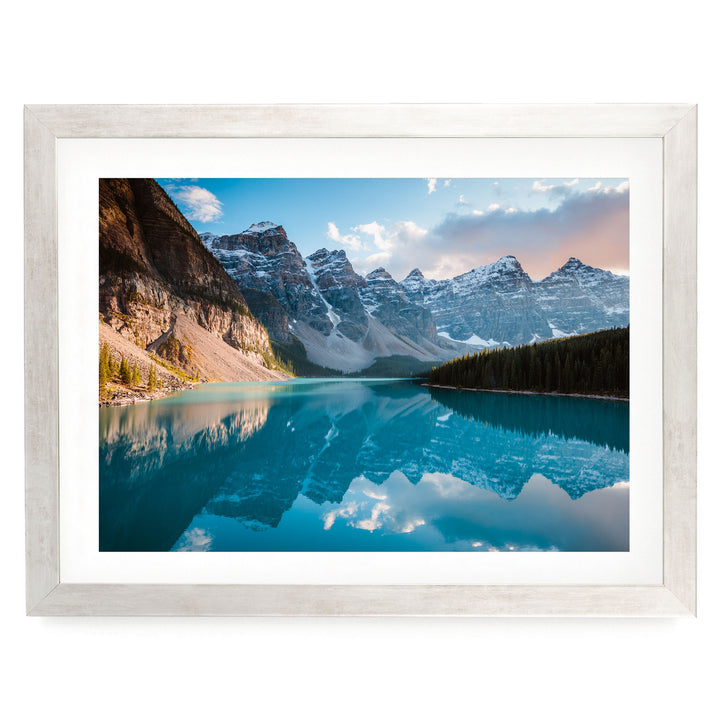 a serene mountain landscape with a stunning blue lake reflecting the surrounding peaks and sky.