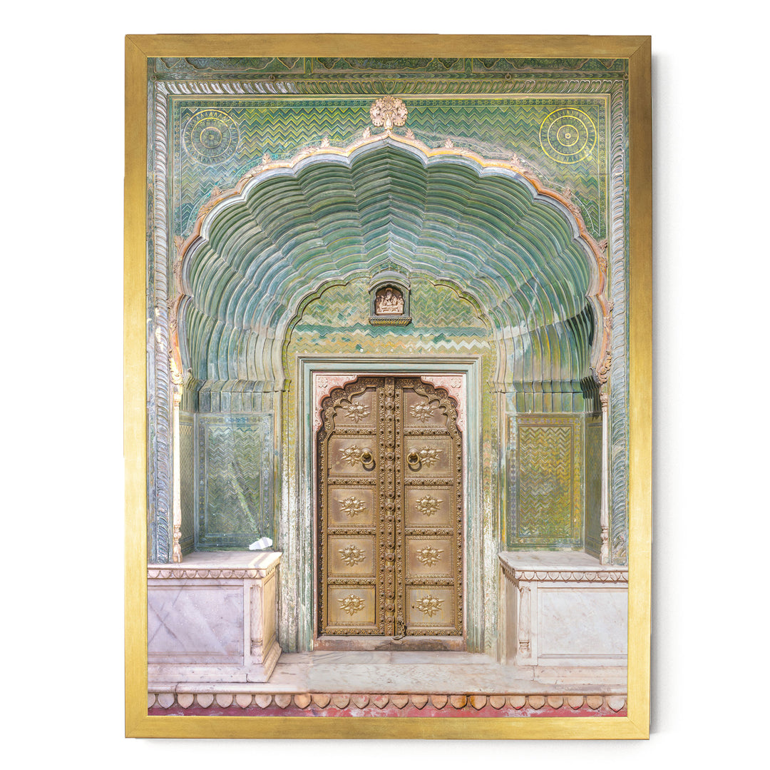 a large, ornate golden door with intricate carvings and patterns, set within an elaborate archway.