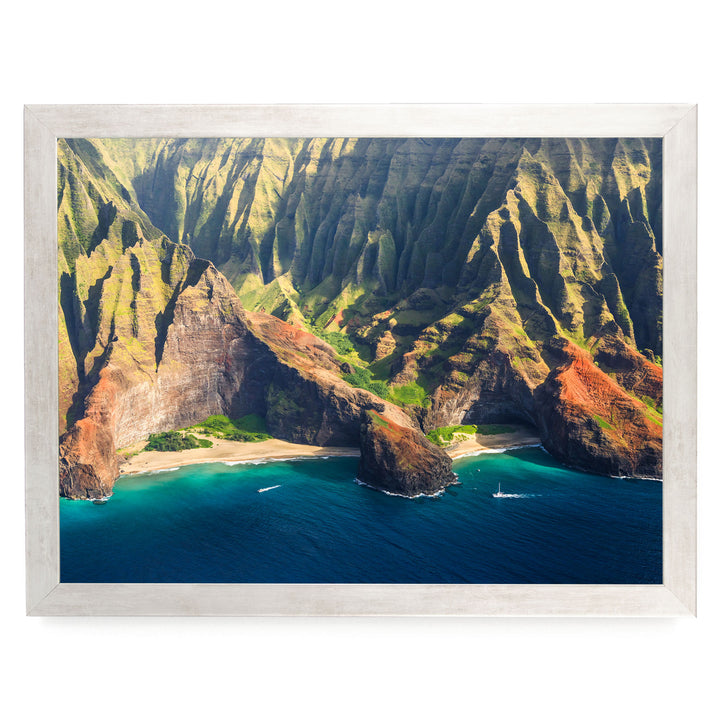 a stunning coastal landscape with towering cliffs, a deep blue ocean, and a sandy beach.
