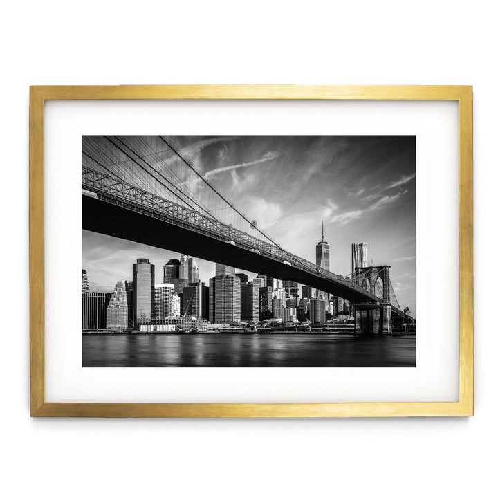 a black and white photo of a bridge and a city