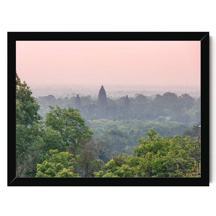 A lush, verdant landscape with a dense forest in the foreground and a hazy, pinkish sky in the background.