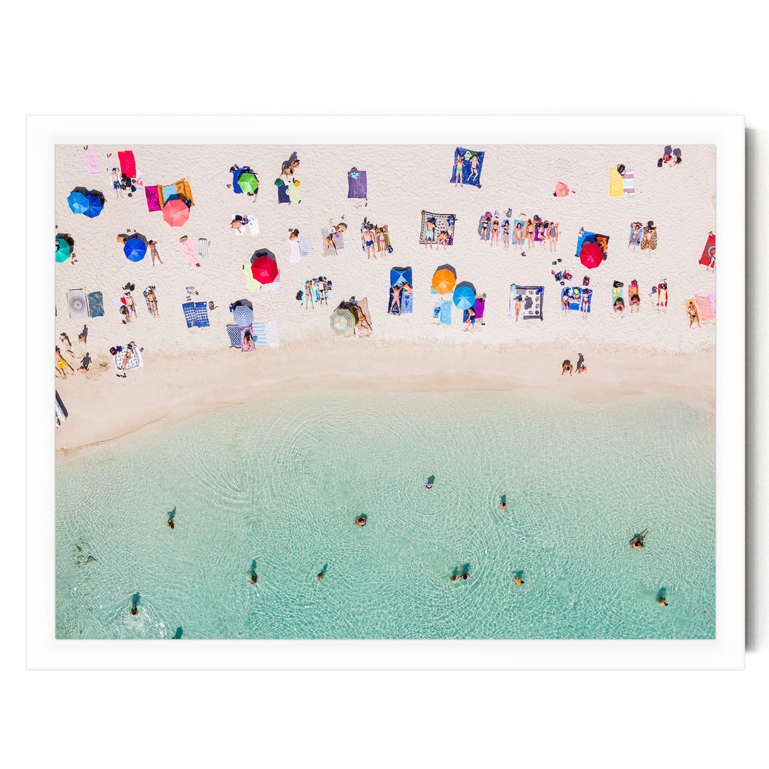 a crowded beach with numerous people enjoying the sun, sand, and water.
