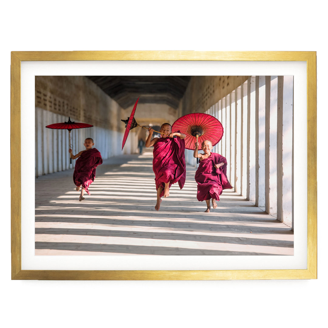 Joyful Monks II, Southeast Asia – fine art print in a gold frame with white mat