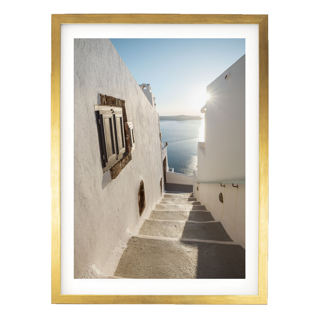 Walking in Oia, Santorini, Greece – fine art print in a gold frame with white mat
