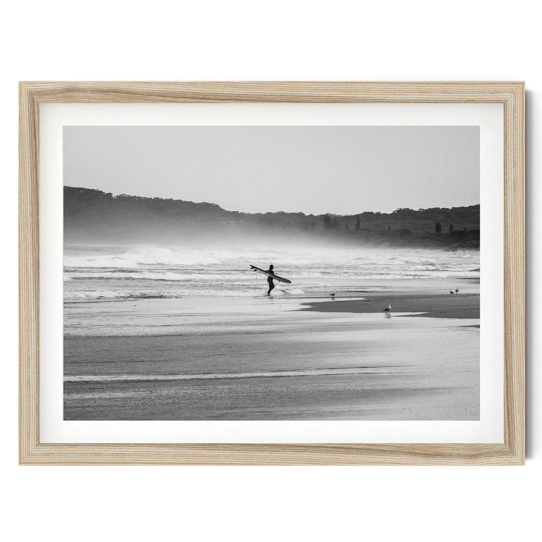 Lone Female Surfer, Byron Bay, Australia – B&W – fine art print in a natural frame with white mat