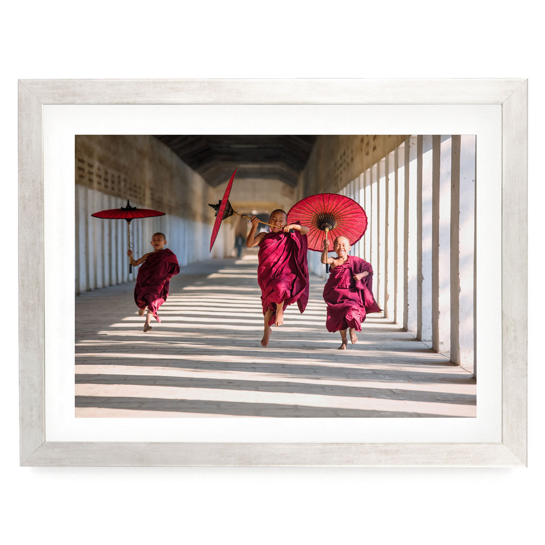Joyful Monks II, Southeast Asia – fine art print in a silver frame with white mat