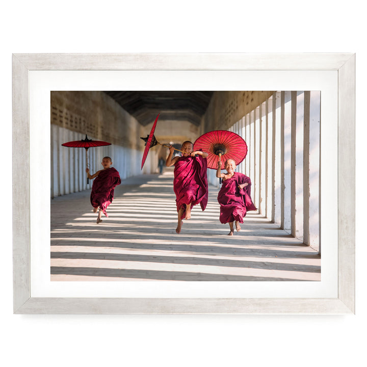 Joyful Monks II, Southeast Asia – fine art print in a silver frame with white mat