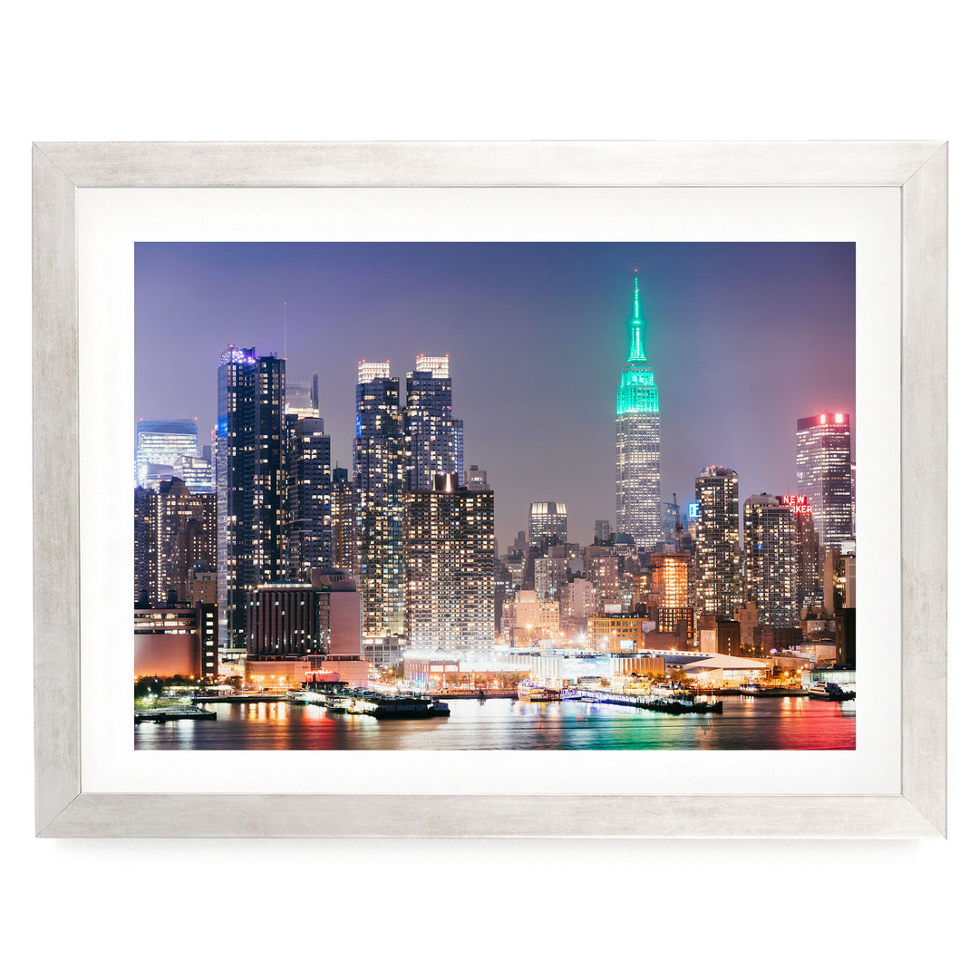 New York Skyline at Night – fine art print in a silver frame with white mat